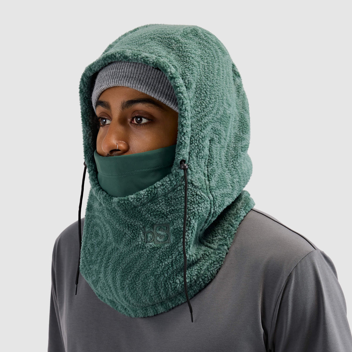 BlackStrap Caldera Hood Sherpa Fleece Overhood Inprint Obsidian worn by a man wearing a beanie #color_inprint-obsidian