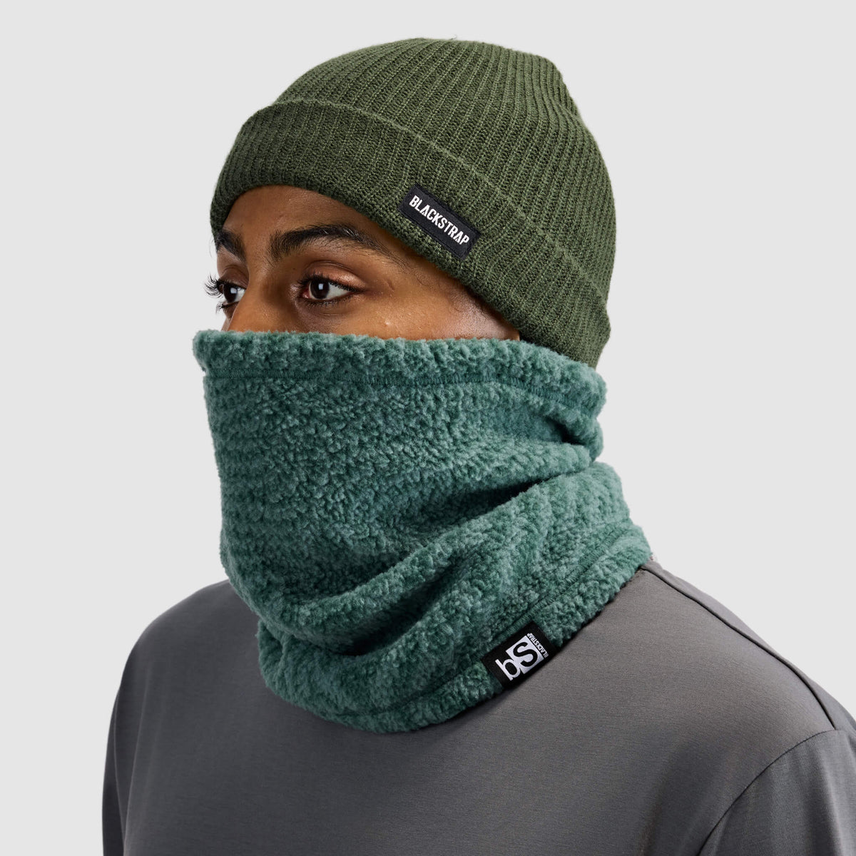 BlackStrap Caldera Sherpa Fleece Tube Neck Gaiter Inprint Obsidian worn by a man with a beanie #color_inprint-obsidian
