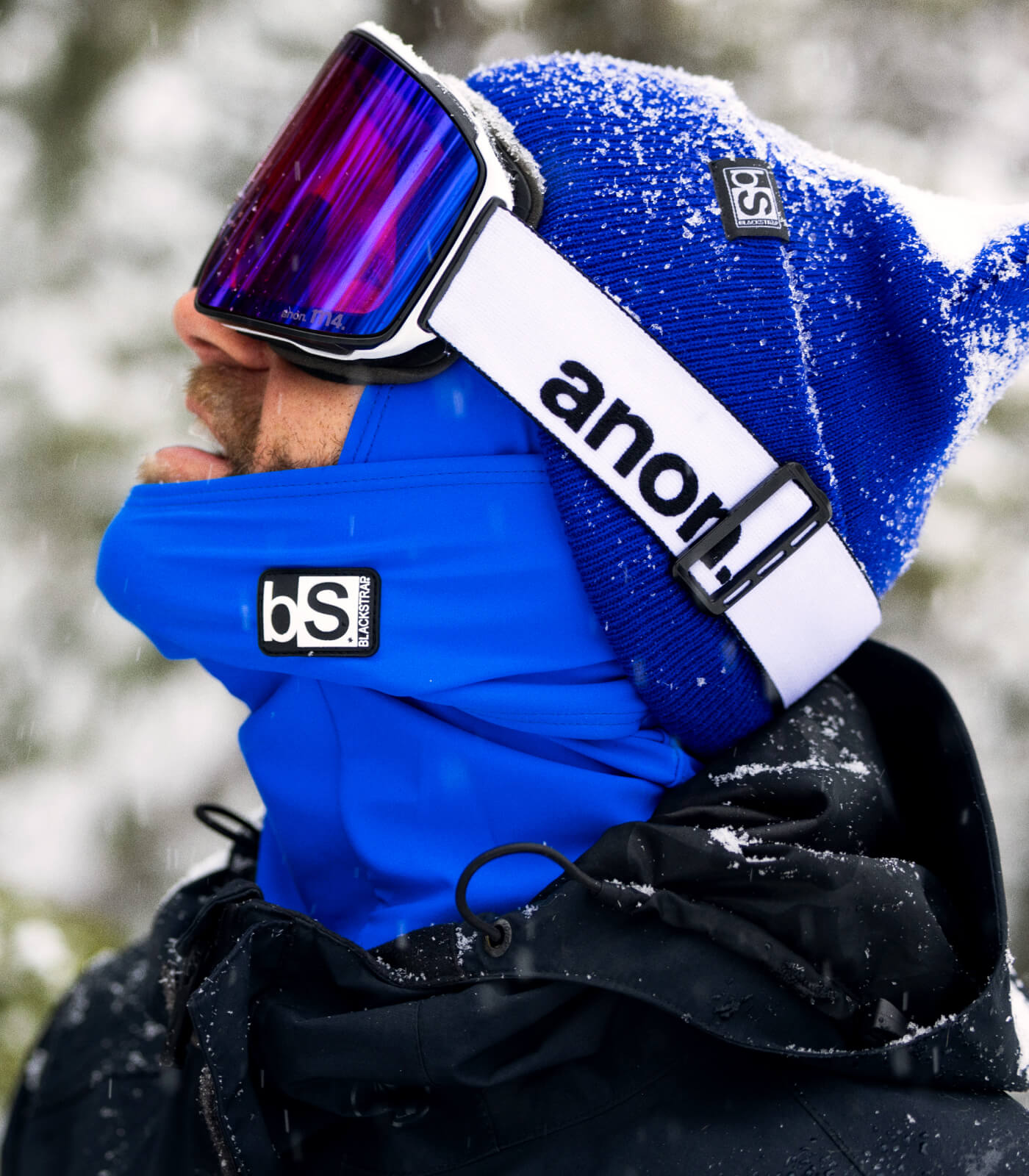 Blue Out! Man enjoy the snow in his blue balaclava and blue essential beanie