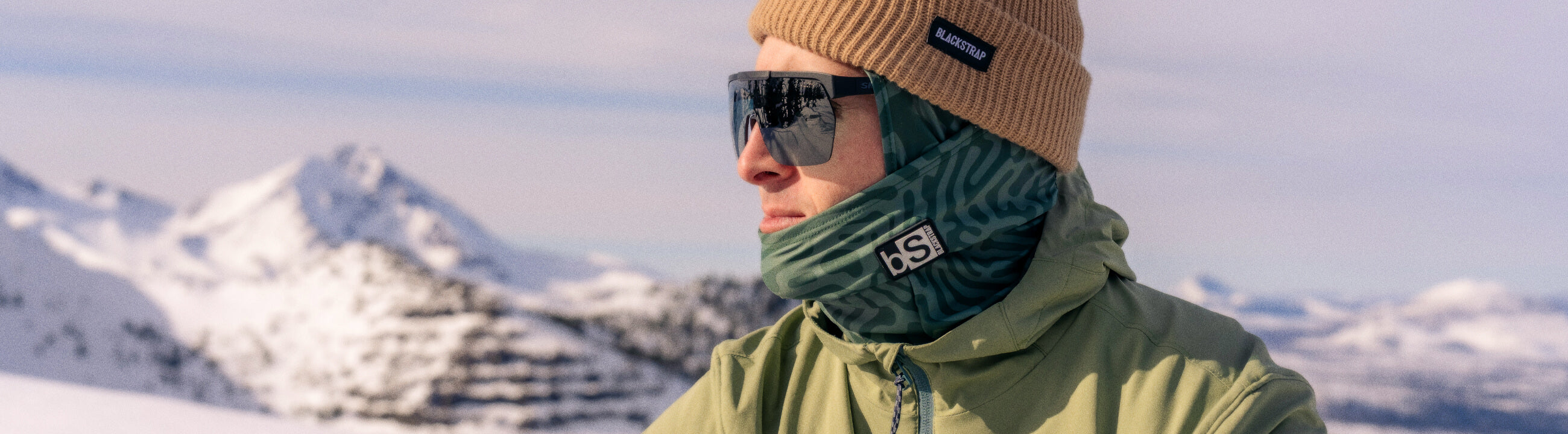 Man staring off at the summit determining his line for his ride.