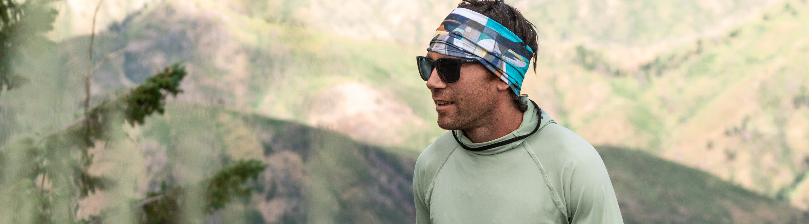 Man Hiking with the Multifunctional headband holding his glasses in place.