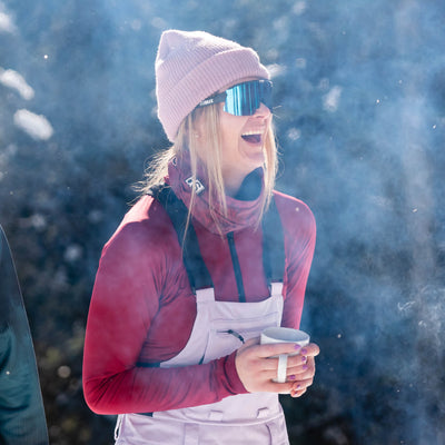 Enjoying her time by the fire sipping some coffee