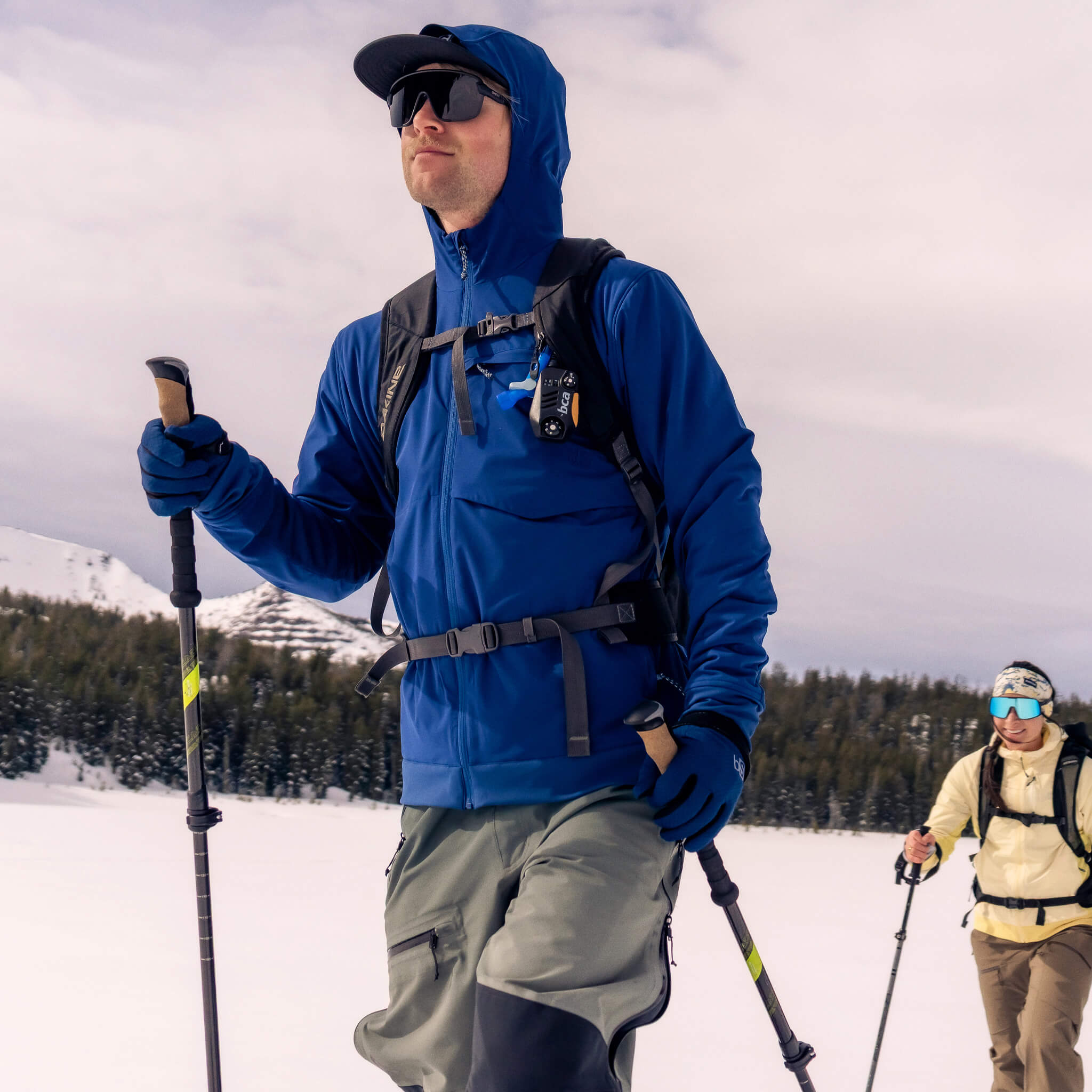 Male wearing the blackstrap Tribrid hooded jacket backcountry skiing