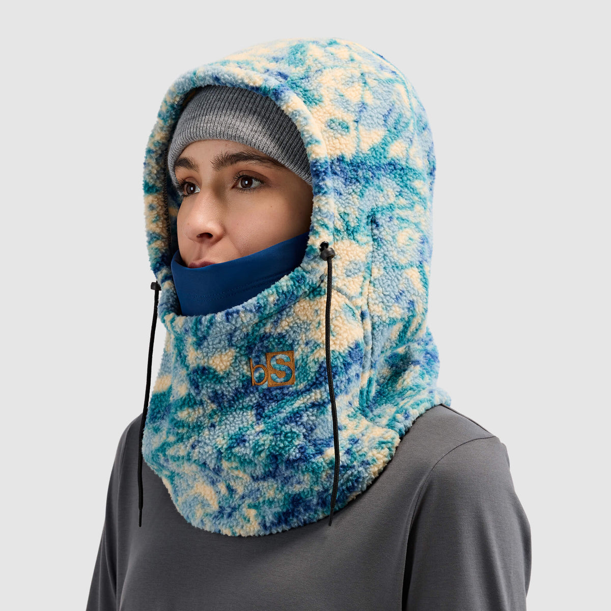 BlackStrap Caldera Hood Sherpa Fleece Overhood Pulse Deschutes worn by a woman wearing a beanie #color_pulse-deschutes