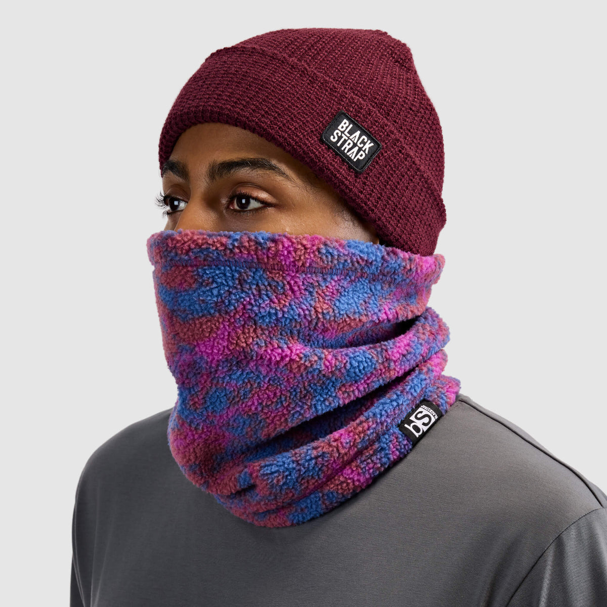 BlackStrap Caldera Sherpa Fleece Tube Neck Gaiter Pulse Currant worn by a man with a beanie #color_pulse-currant