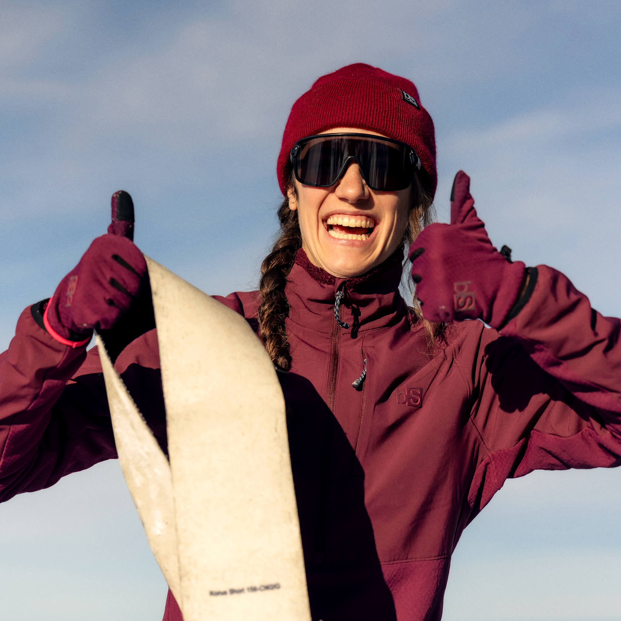Female in her Tribrid Cherry Colorway kit taking the skims off the 