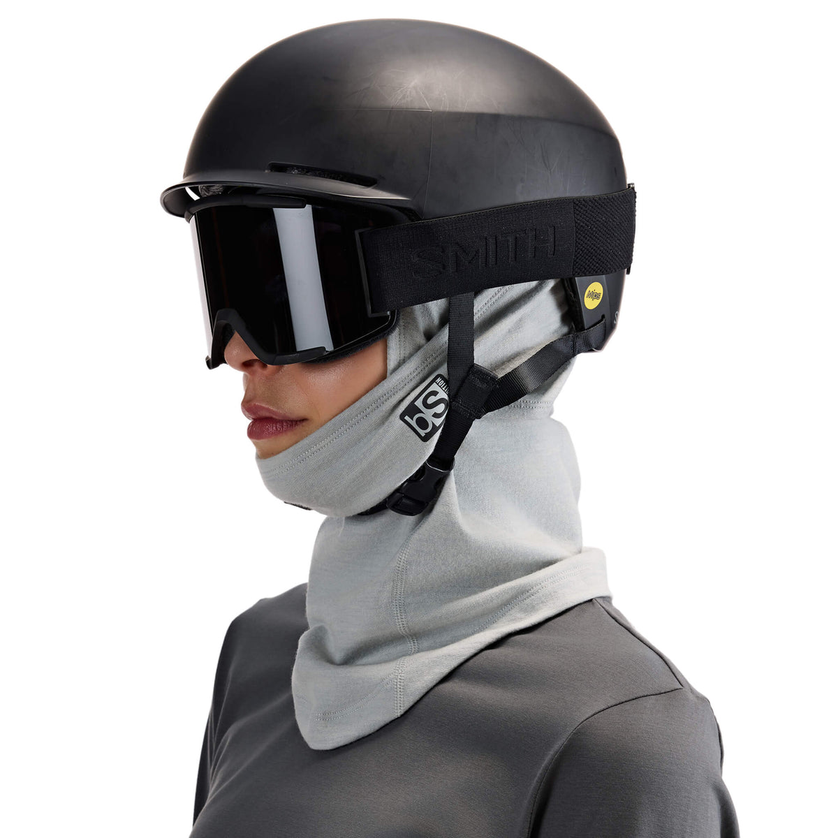 BlackStrap Merino Expedition Hood Balaclava worn under a helmet and ski goggles with the Exohinge pulled down under the chin