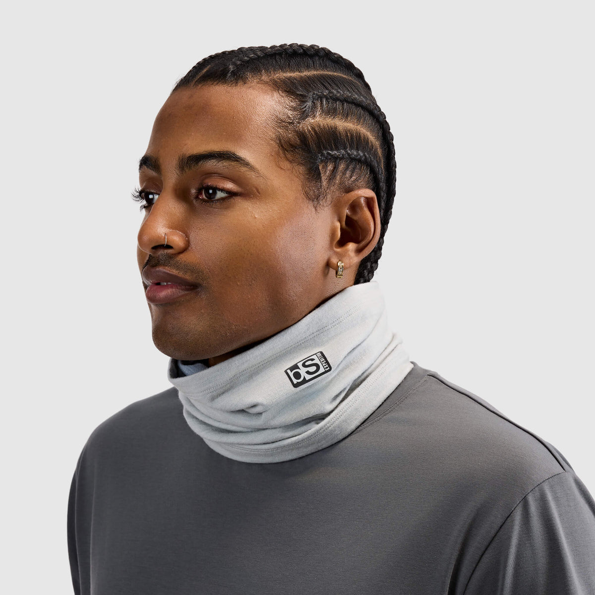 BlackStrap Merino Expedition Tube Neck Gaiter in Ash worn around the neck like a scarf by a man