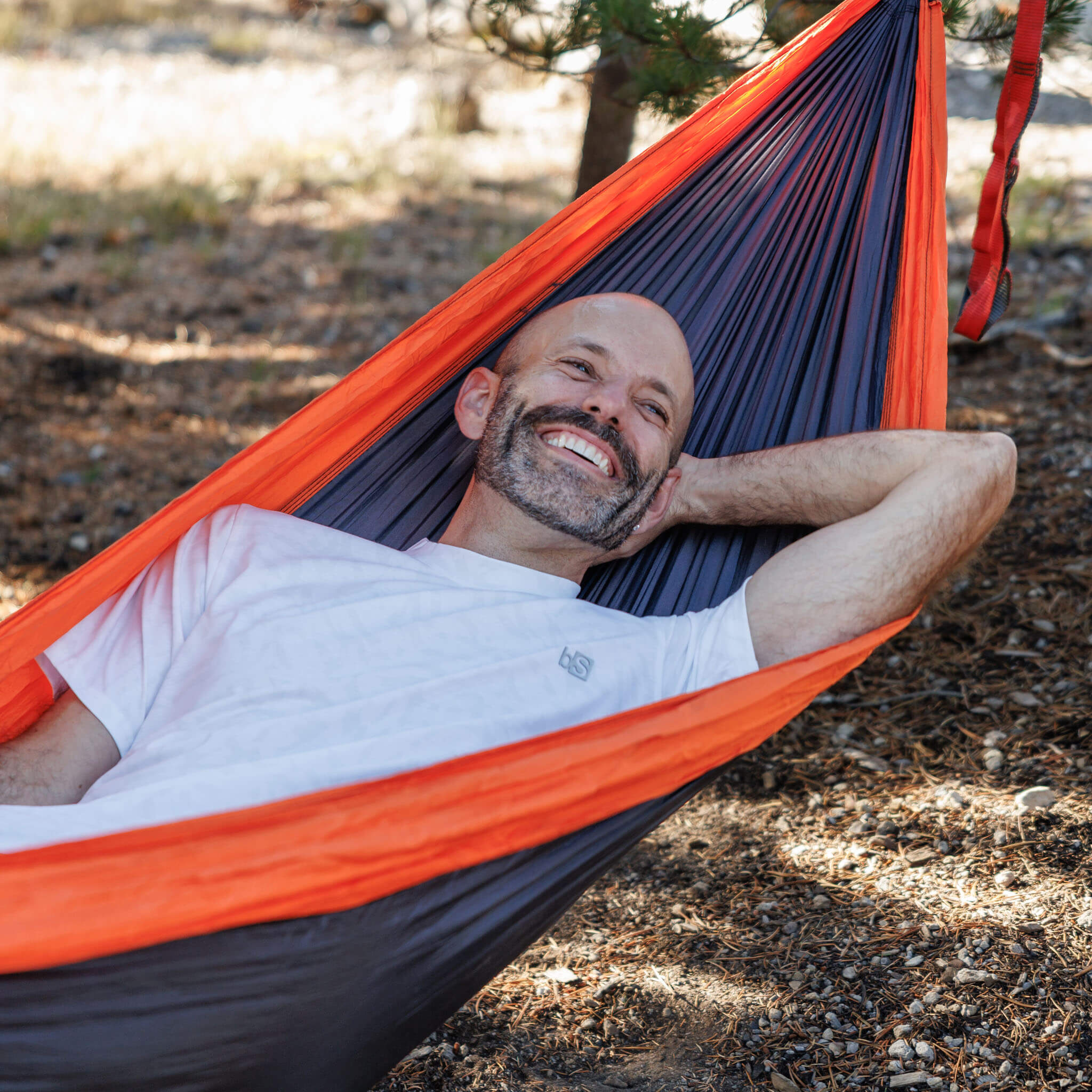 Man relaxing in a hammock in a pine forest wearing the BlackStrap Men's Aspect Tee #color_ripple ash