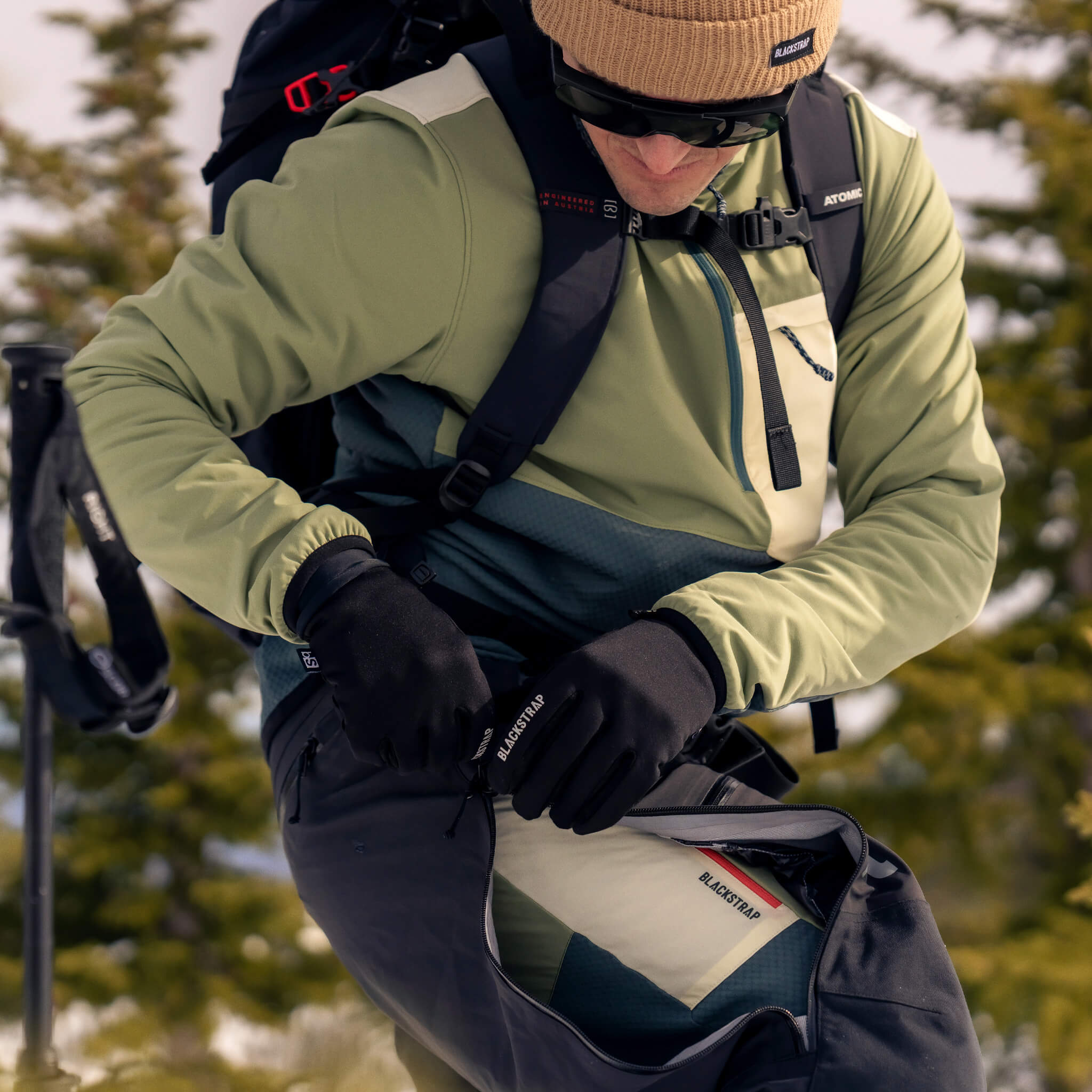 man wearing the BlackStrap Tribrid crew jacket in the backcountry to ski